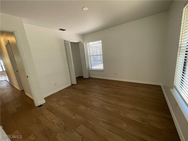 9882 Connecticut St, Bonita Springs, FL 34135 - spare room with visible vents, baseboards, and dark wood-style flooring