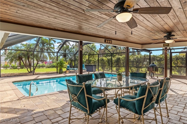 view of pool with a patio, a lanai, and ceiling fan