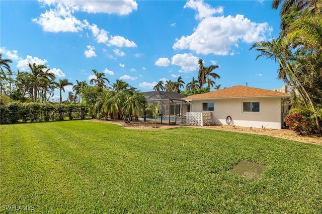 view of yard featuring a swimming pool and a lanai