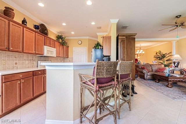 kitchen with ceiling fan with notable chandelier, stainless steel fridge, ornamental molding, tasteful backsplash, and light tile patterned flooring