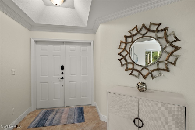 tiled foyer entrance featuring ornamental molding