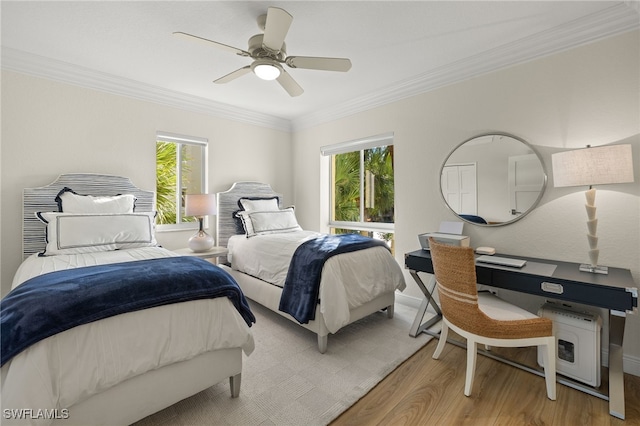 bedroom with ceiling fan, light wood-type flooring, ornamental molding, and multiple windows