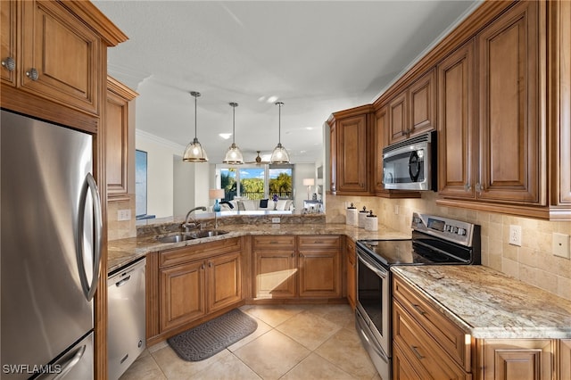 kitchen featuring crown molding, sink, hanging light fixtures, light stone countertops, and stainless steel appliances