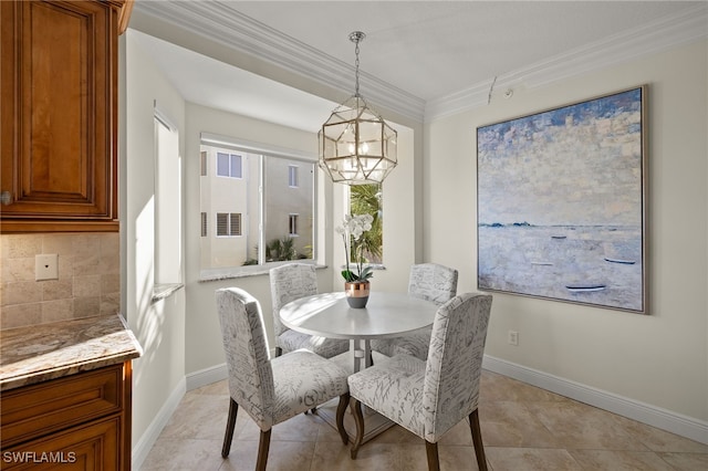 dining area featuring crown molding and a chandelier