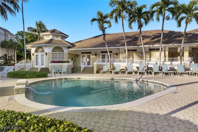 view of swimming pool with french doors