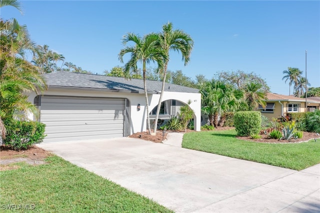 ranch-style house featuring a garage and a front lawn