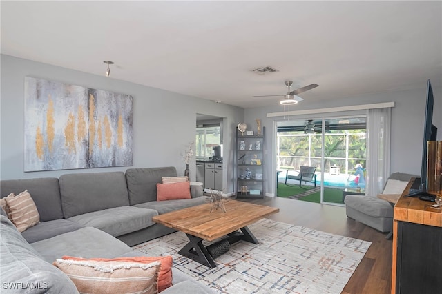 living room featuring hardwood / wood-style flooring and ceiling fan