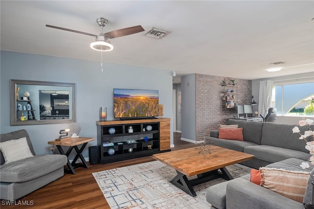 living room featuring hardwood / wood-style floors and ceiling fan