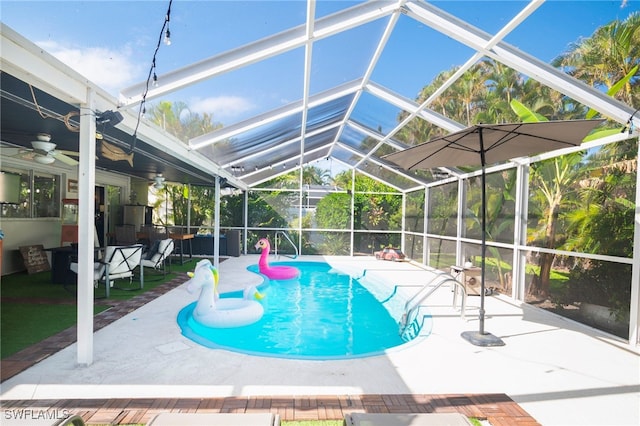 view of swimming pool featuring a lanai, ceiling fan, and a patio