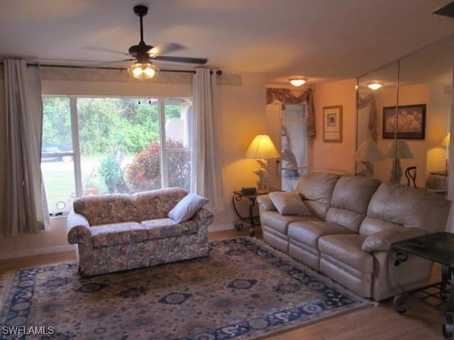 living room featuring wood-type flooring and ceiling fan