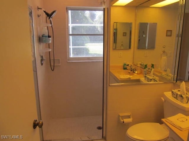 bathroom featuring toilet and a shower with shower door