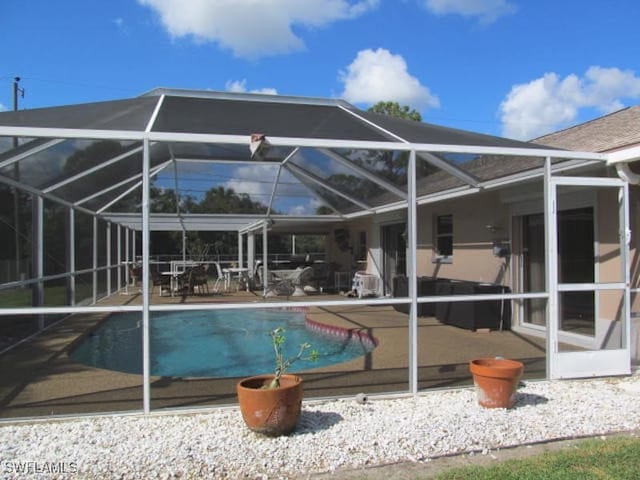 view of pool with a lanai and a patio