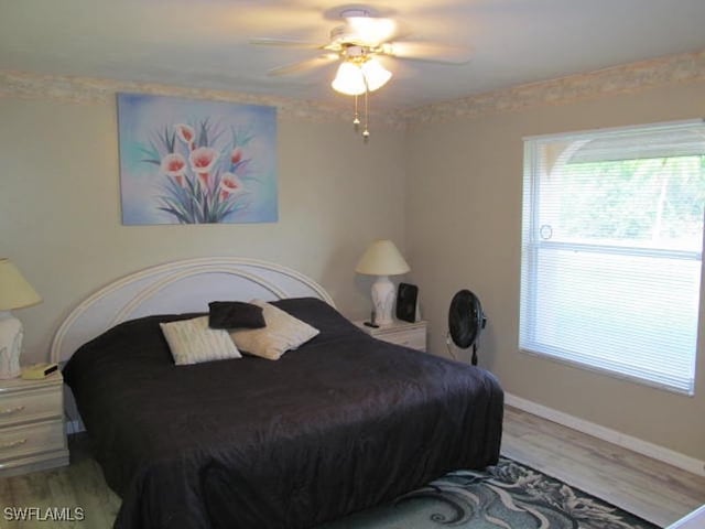 bedroom with hardwood / wood-style flooring and ceiling fan