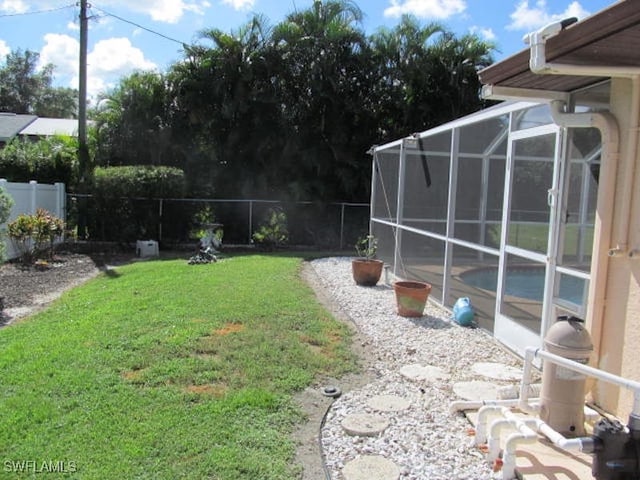 view of yard featuring glass enclosure