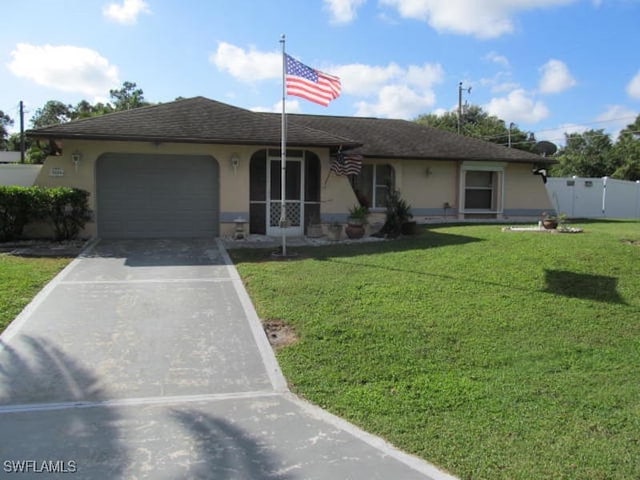 single story home featuring a garage and a front yard