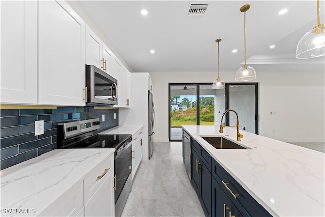 kitchen with stainless steel appliances, a sink, white cabinetry, light stone countertops, and pendant lighting