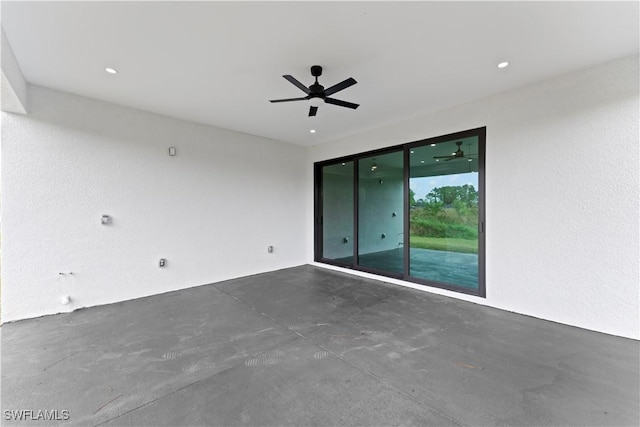 empty room featuring concrete floors and ceiling fan