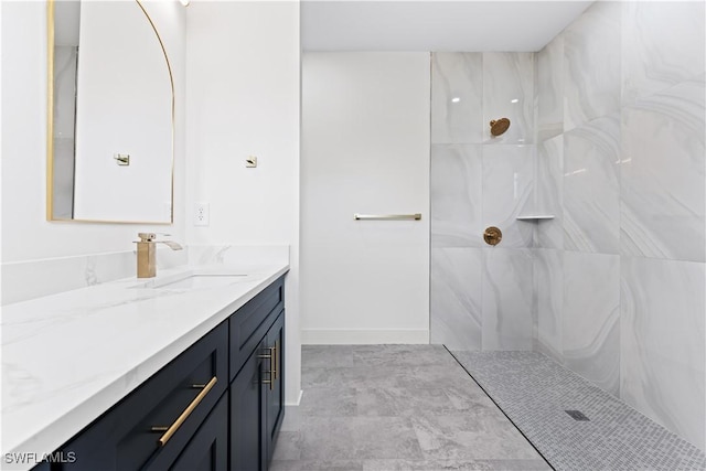 full bath with baseboards, a shower, and vanity