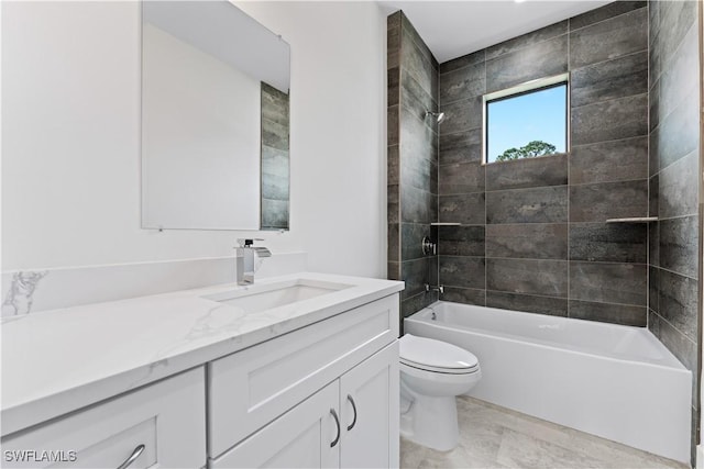 full bathroom with tiled shower / bath, vanity, and toilet