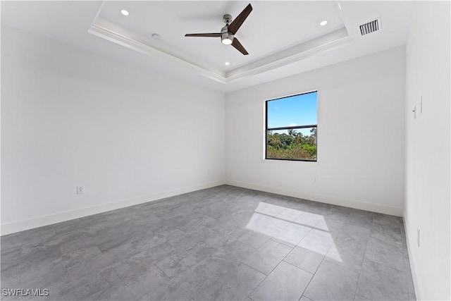 unfurnished room with baseboards, visible vents, a raised ceiling, ceiling fan, and recessed lighting