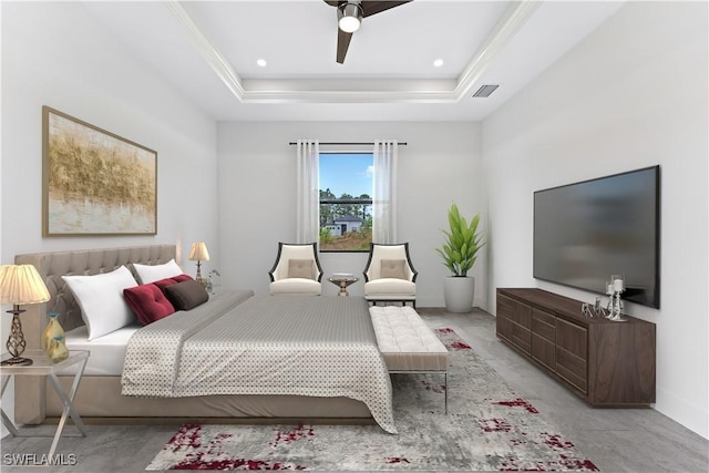 carpeted bedroom featuring ceiling fan and a tray ceiling