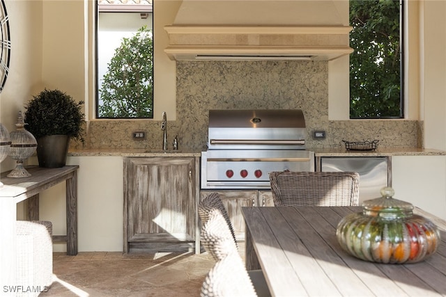 view of patio featuring grilling area, sink, and exterior kitchen