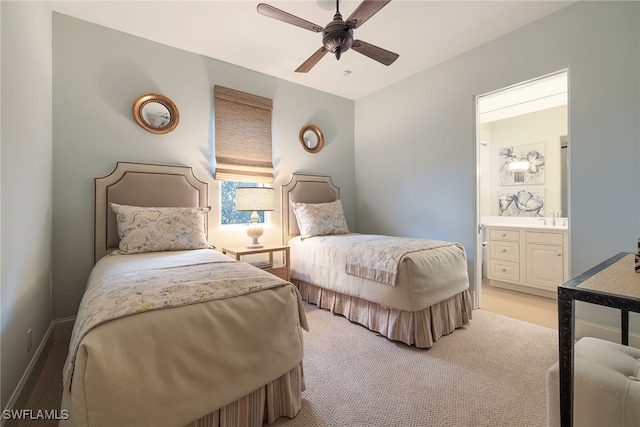 carpeted bedroom with ceiling fan, sink, and connected bathroom