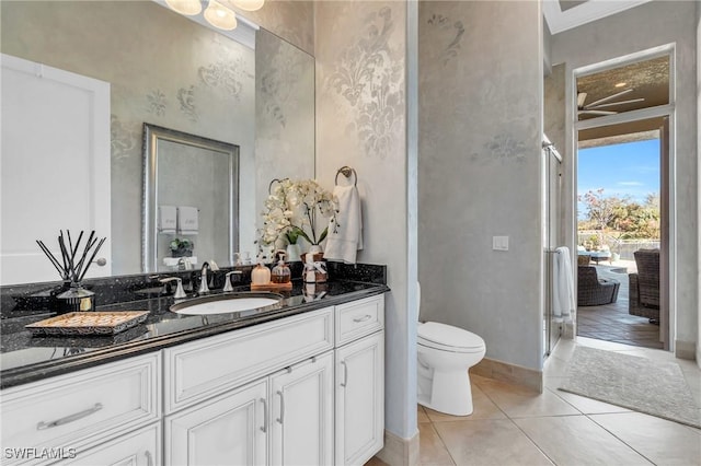 bathroom featuring tile patterned floors, vanity, toilet, and crown molding