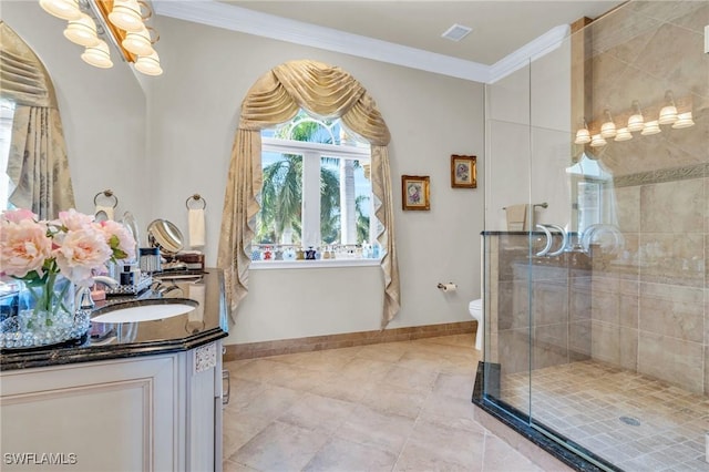 bathroom with vanity, toilet, a shower with shower door, and crown molding