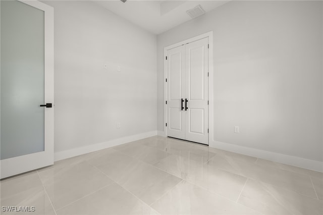 spare room with light tile patterned floors