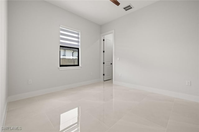 728 SW 8th Ter, Cape Coral, FL 33991 - tiled spare room featuring baseboards and ceiling fan
