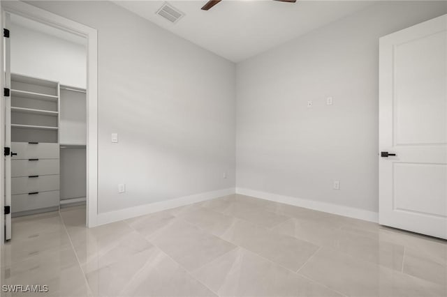 728 SW 8th Ter, Cape Coral, FL 33991 - unfurnished bedroom featuring baseboards, a walk in closet, ceiling fan, and a closet