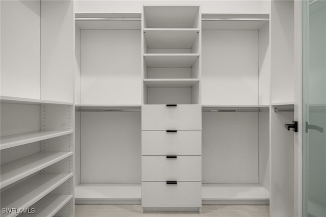 spacious closet featuring light tile patterned floors