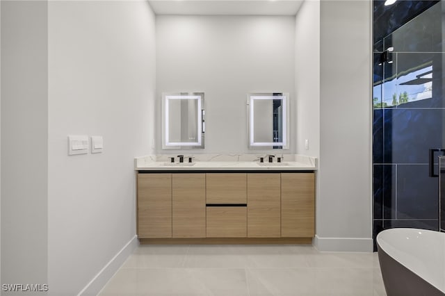 bathroom with vanity, a tub to relax in, and tile patterned floors