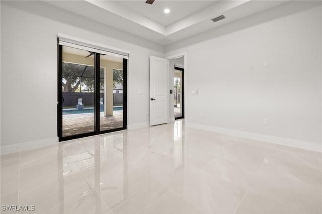 728 SW 8th Ter, Cape Coral, FL 33991 - unfurnished room with light tile patterned flooring, ceiling fan, recessed lighting, baseboards, and a tray ceiling