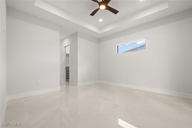728 SW 8th Ter, Cape Coral, FL 33991 - spare room featuring a raised ceiling, ceiling fan, recessed lighting, baseboards, and light tile patterned floors