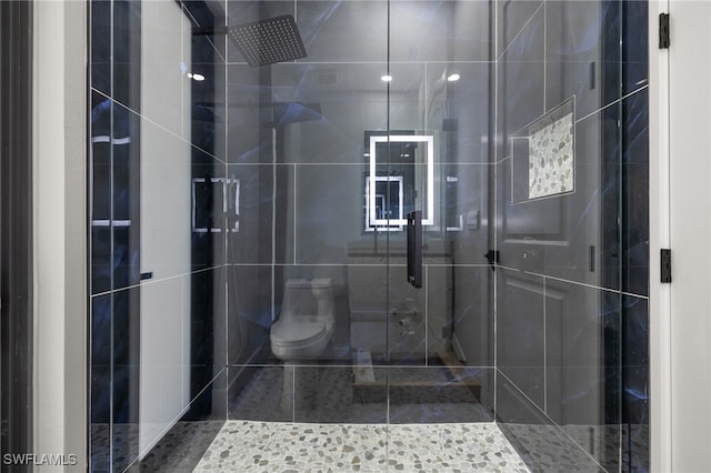 bathroom with an enclosed shower and toilet