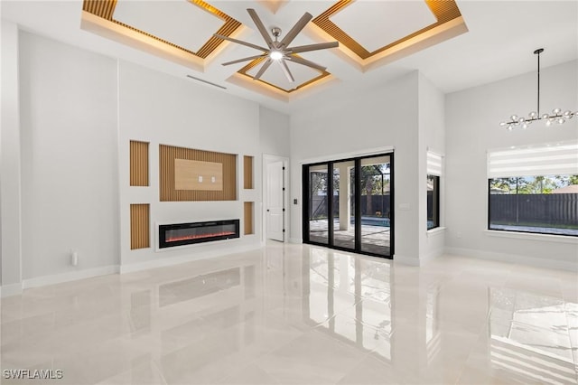 728 SW 8th Ter, Cape Coral, FL 33991 - unfurnished living room featuring tile patterned flooring, a glass covered fireplace, healthy amount of natural light, a ceiling fan, and a high ceiling