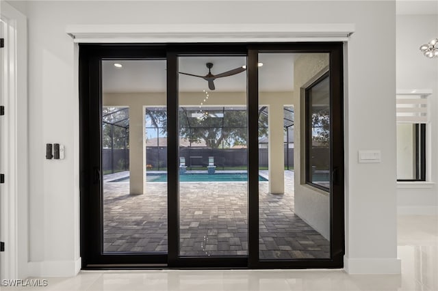 entryway with ceiling fan and tile patterned floors