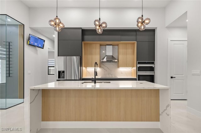 728 SW 8th Ter, Cape Coral, FL 33991 - kitchen with stainless steel appliances, wall chimney exhaust hood, modern cabinets, a sink, and baseboards