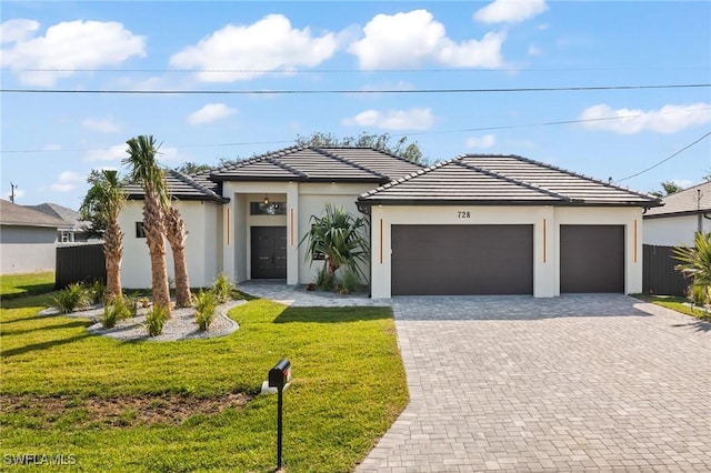 728 SW 8th Ter, Cape Coral, FL 33991 - view of front of property featuring driveway, a garage, a tile roof, and stucco siding