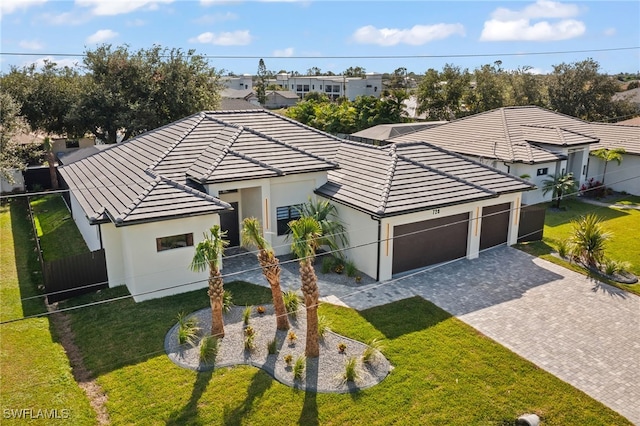 single story home featuring a garage and a front yard