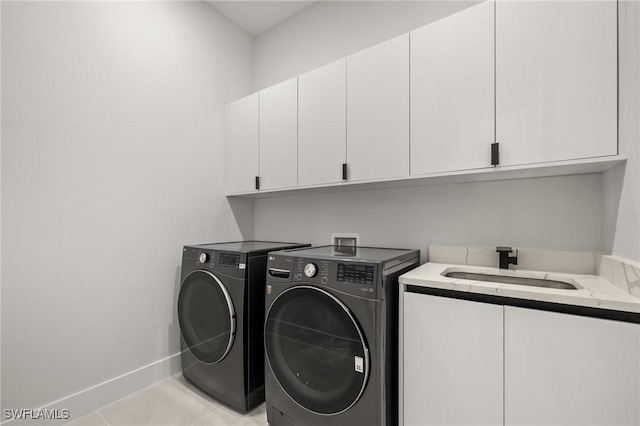 728 SW 8th Ter, Cape Coral, FL 33991 - clothes washing area featuring cabinet space, washer and clothes dryer, baseboards, and light tile patterned floors