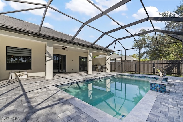 view of swimming pool featuring a lanai, ceiling fan, and a patio area