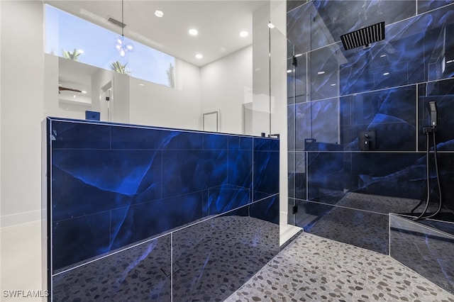 bathroom with tile walls and a tile shower