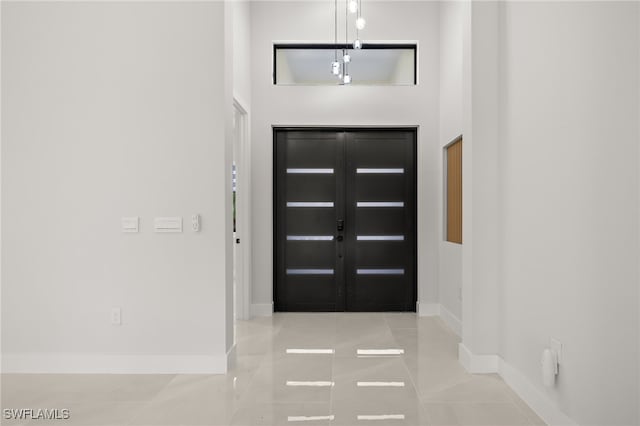 tiled foyer entrance with a high ceiling