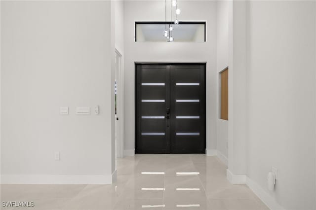 728 SW 8th Ter, Cape Coral, FL 33991 - foyer with baseboards and tile patterned flooring