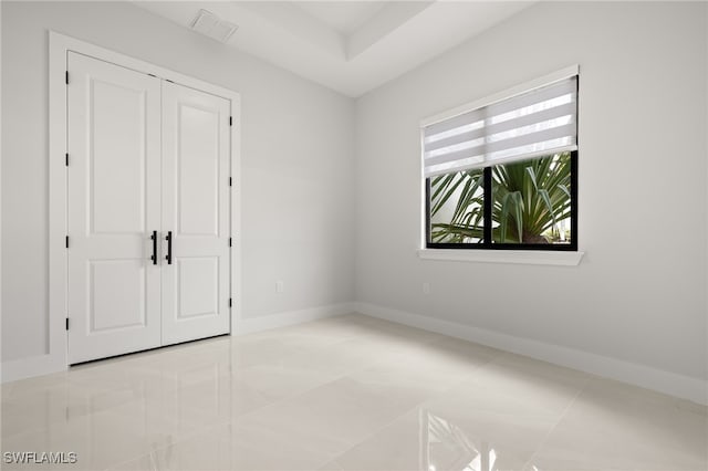 unfurnished bedroom with light tile patterned floors and a closet