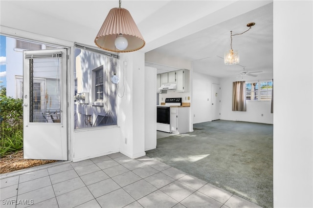 kitchen with pendant lighting, ceiling fan, white electric range, and light carpet