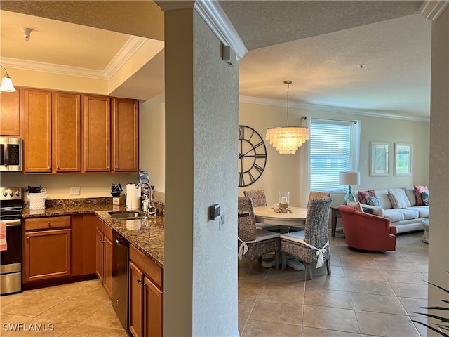 kitchen with crown molding, stainless steel appliances, a textured ceiling, pendant lighting, and sink